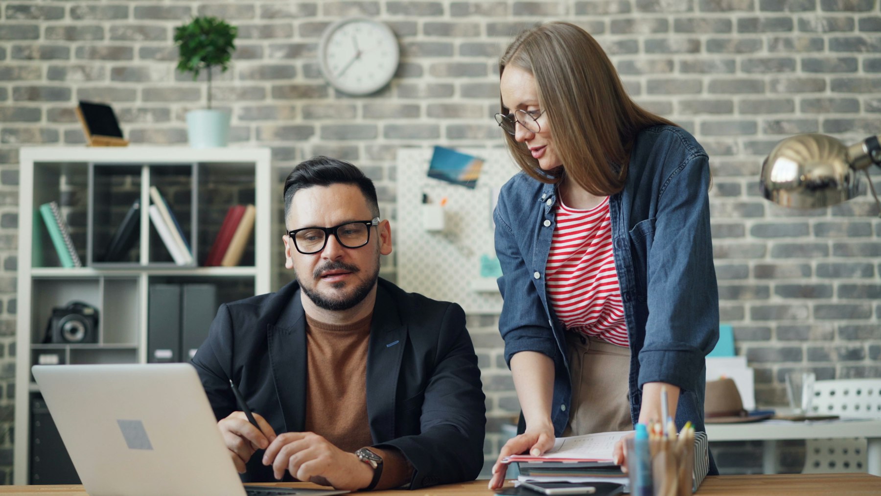 Two people looking at a laptop together