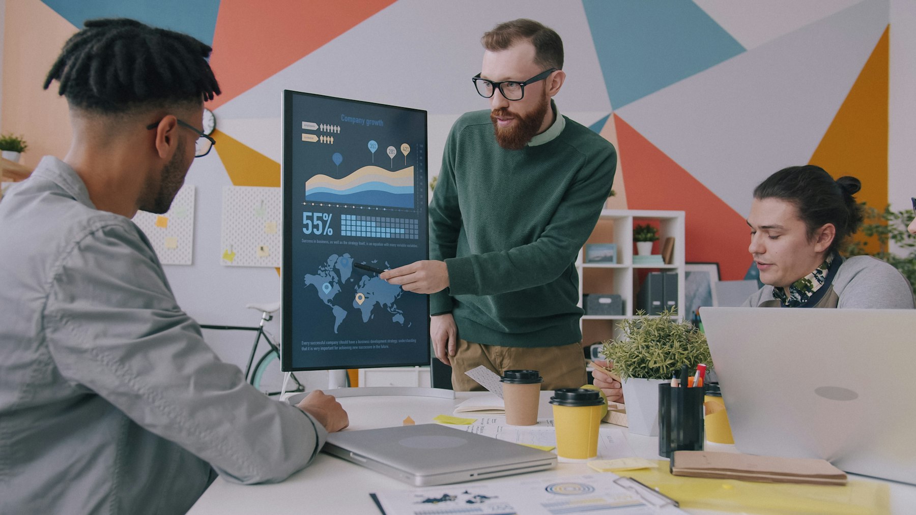 A team looking at charts on a monitor